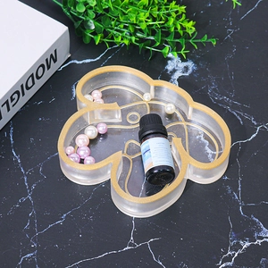 Detailed view of bear-shaped resin jewelry tray with golden edges and decorative pearls