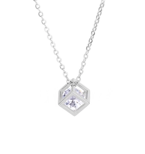 Macro view of geometric hollow cube pendant with sparkling zircon on silver chain
