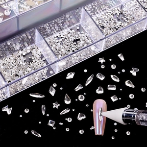 Macro view of 21-grid nail art rhinestones set with wax pen on black background