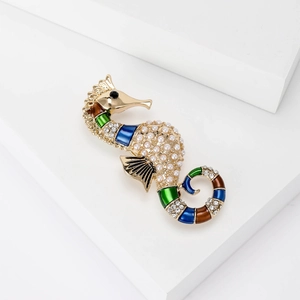 Golden seahorse brooch featuring white pearls and colorful enamel with crystals