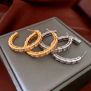 Luxury snake scale hoop earrings with cubic zirconia inlay in gold and silver finish