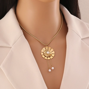 Collier fleur dorée élégant avec perles blanches porté par un mannequin sur un costume