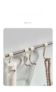 Detail of stainless steel round hooks with protective tips on a sliding bathroom rail