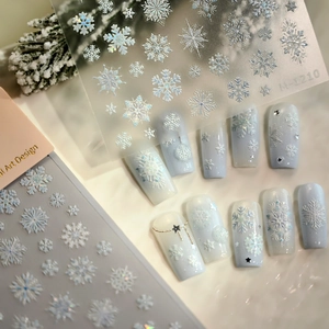 3D embossed snowflake nail art stickers with iridescent finish on almond shaped nails