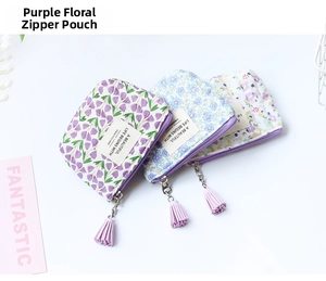 Close-up of floral quilted coin purses with zipper closure and decorative tassels