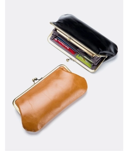 Macro view of kiss-lock leather wallets with accordion compartments for cards and cash