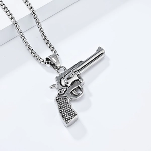Macro detail of silver hip hop revolver pendant necklace with vintage metallic texture