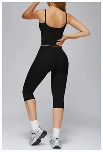 Rear view of black high-waisted yoga pants and tank top set showing slim fit and fabric