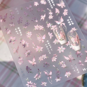 Pink lily and butterfly nail art stickers with iridescent finish and artistic script