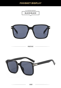 Detail view of black square oversized sunglasses with metallic hinges and dark lenses