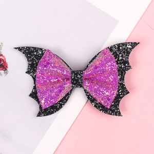 Detail of pink and black glitter hair bow with bat wings for Halloween party styling