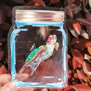 Holographic sea turtle in a jar sticker showing colorful rainbow prism light effects