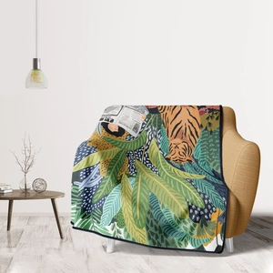 Close-up of a vintage jungle tiger flannel blanket draped on a cozy yellow chair