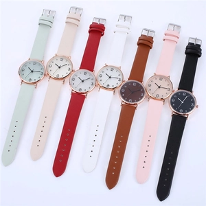 Flat lay of women's quartz watches in seven assorted colors with stylish leather bands