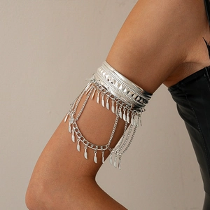 Detail of silver bohemian arm cuff with tiered chains and hanging leaf feather charms