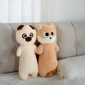 Detailed view of long cartoon dog plush pillow covers in beige and orange on a soft bed