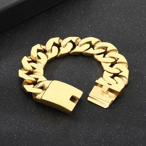 Detail of a 24mm heavy gold Cuban link bracelet with flat links and secure side clasp