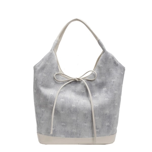 Chic grey polka dot bucket bag with white bow print and contrast beige leather base