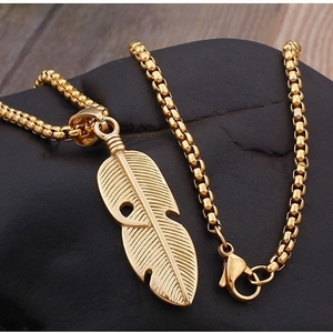 Hip hop vintage hollow feather pendant necklace in gold stainless steel on wood