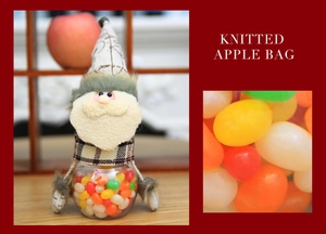 Detail of Santa Claus knitted candy jar with clear container and green plush trim