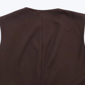 Detailed view of dark brown asymmetric top showing twill fabric texture and back seam