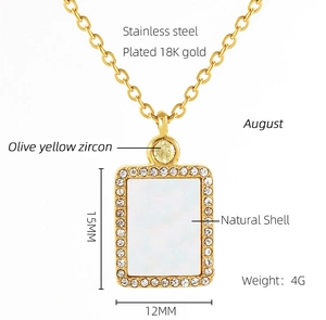 Detail of 18K gold-plated necklace with olive yellow zircon and natural shell pendant