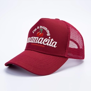 Burgundy trucker hat featuring Mamaeita embroidery and cherry graphics in a 45-degree angle