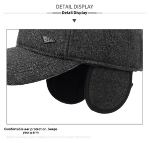 Detail view of the warm ear flaps and wool texture on the gray winter baseball cap