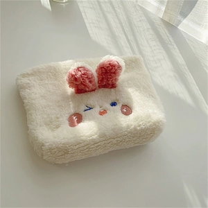 Close-up of soft white plush bunny storage bag featuring pink ears and cute embroidery
