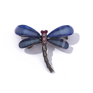 Detail of dragonfly brooch featuring blue gradient wings and pink crystal rhinestones