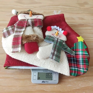 Macro detail of two snowman Christmas stockings with red burlap texture and plush 3D decor