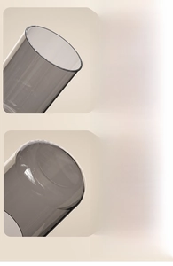 Detail of dark gray translucent glass cup with smooth rounded rim and thickened bottom