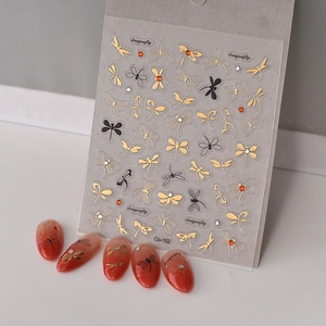 Macro view of 5D gold embossed dragonfly nail stickers and Co-152 manicure nail art set
