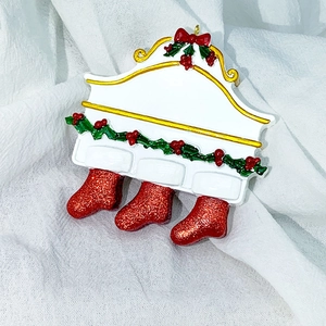 Detailed view of 3-sock resin Christmas pendant with gold trim and glittery red finish