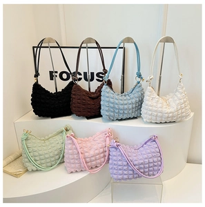 Close-up of textured bubble pleated shoulder bags in seven stylish pastel colors