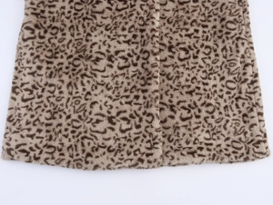 Detail shot of leopard print faux fur coat hemline showing high-quality plush texture