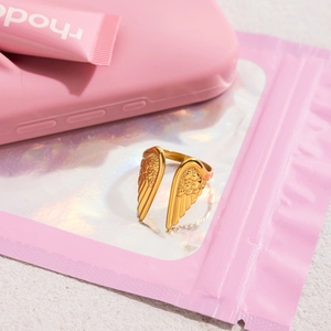 Close-up of golden 18K gold-plated stainless steel angel wing adjustable open ring