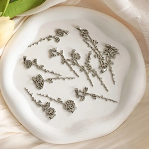Silver stainless steel birth flower pendant necklaces collection on ceramic tray