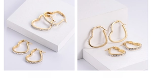 Detailed view of 18k gold plated heart earrings with sparkling white crystals