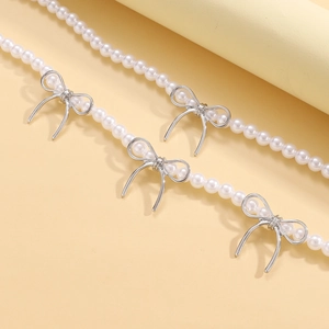 Elegant pearl choker necklace featuring polished silver metal bow pendants for women
