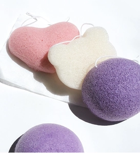 Detail of four colorful biodegradable konjac facial sponges in round heart and bear shapes