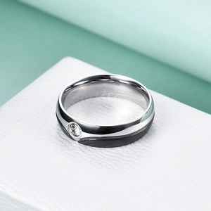 Macro shot of 6mm stainless steel ring with silver and black wave patterns and zircon