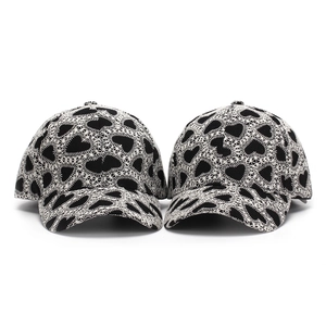 Detail of baseball cap showing heart embroidery and textured fabric stitching