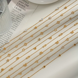 Detail of 18K gold titanium steel bracelets with star, heart, and clover charms