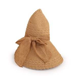 Detailed close-up of woven straw sun hat texture featuring a large decorative bow