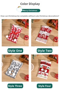 Detail of four Nordic knitted Christmas wine bottle bags with reindeer and snowflake patterns