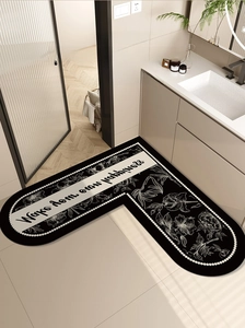 Detail view of L-shaped absorbent bathroom corner mat with black and white floral pattern