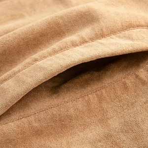 Close-up of tan suede bomber jacket featuring premium texture and durable double stitching