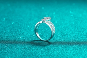 Macro detail of silver crown ring featuring square stone and side diamond pavé