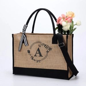 Natural jute tote bag with black trim, shoulder strap and floral letter A print